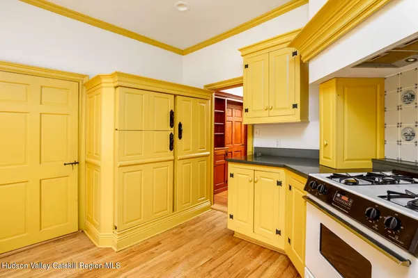 a kitchen with a refrigerator a stove top oven