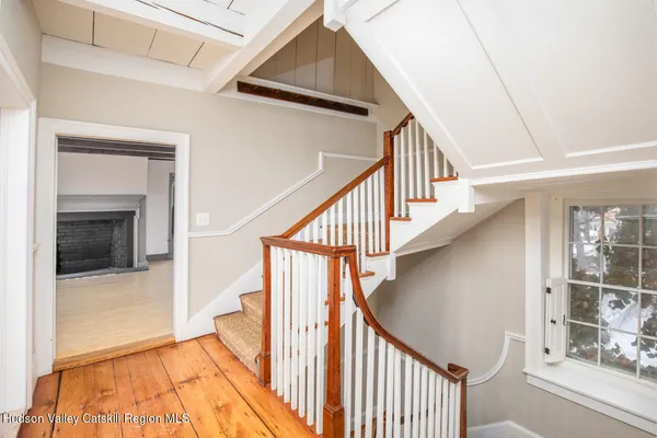 a view of staircase with railing and white walls