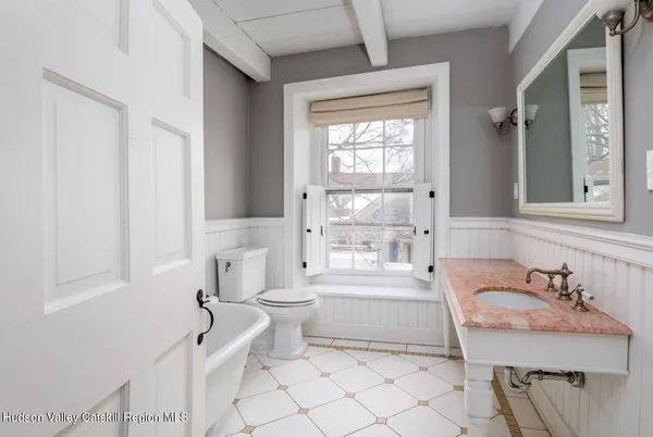 a bathroom with a sink toilet a mirror and shower
