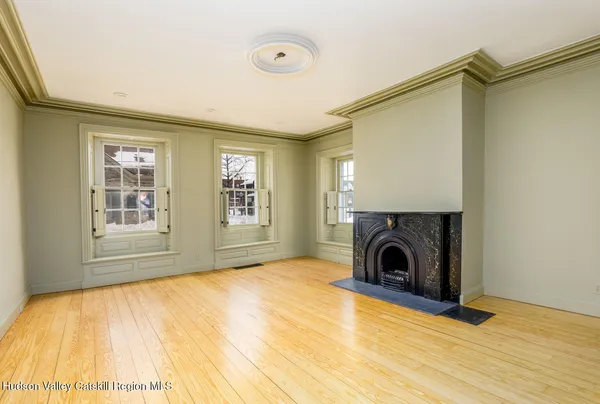 a view of empty room with fireplace and window