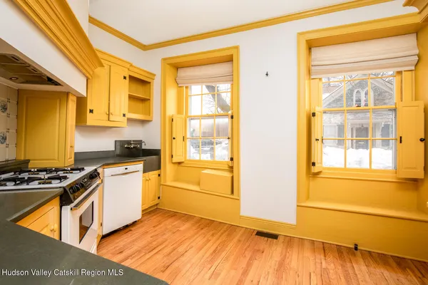 a kitchen with stainless steel appliances granite countertop a stove and a white cabinets