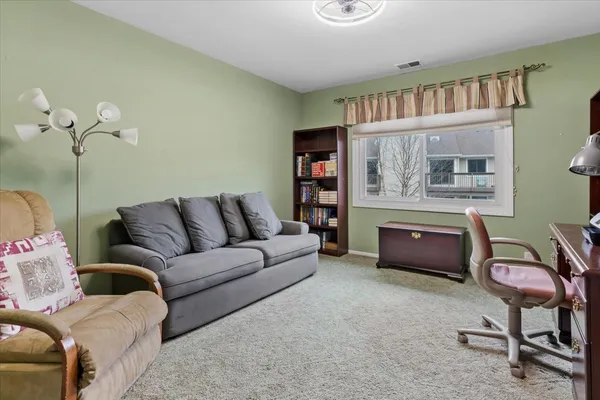a living room with furniture and a book shelf