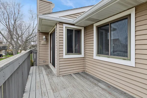 a view of a balcony with wooden floor and fence