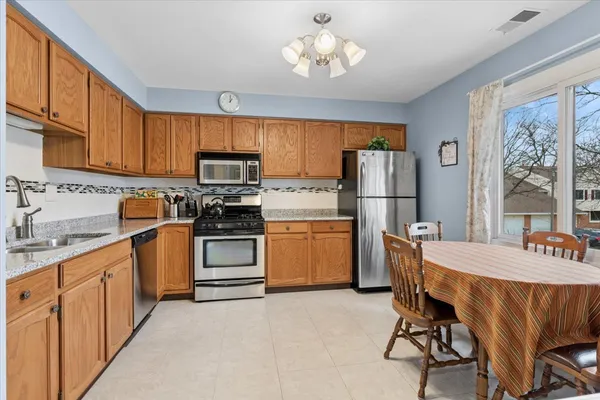 a kitchen with a stove a sink and a refrigerator