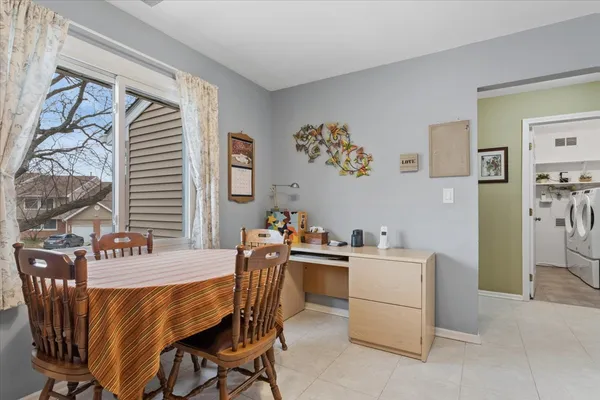 a dining room with furniture and window