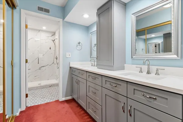 a spacious bathroom with a granite countertop sink mirror and shower