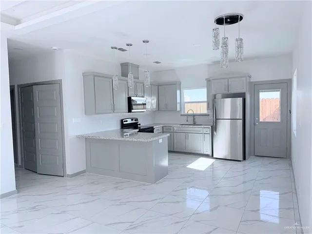 a kitchen with cabinets and stainless steel appliances