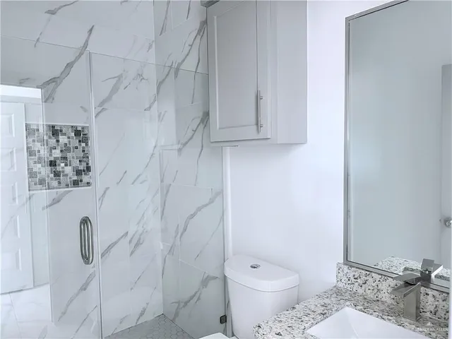 a view of a kitchen with a sink and cabinet