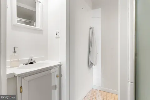 a bathroom with a sink a mirror and shower