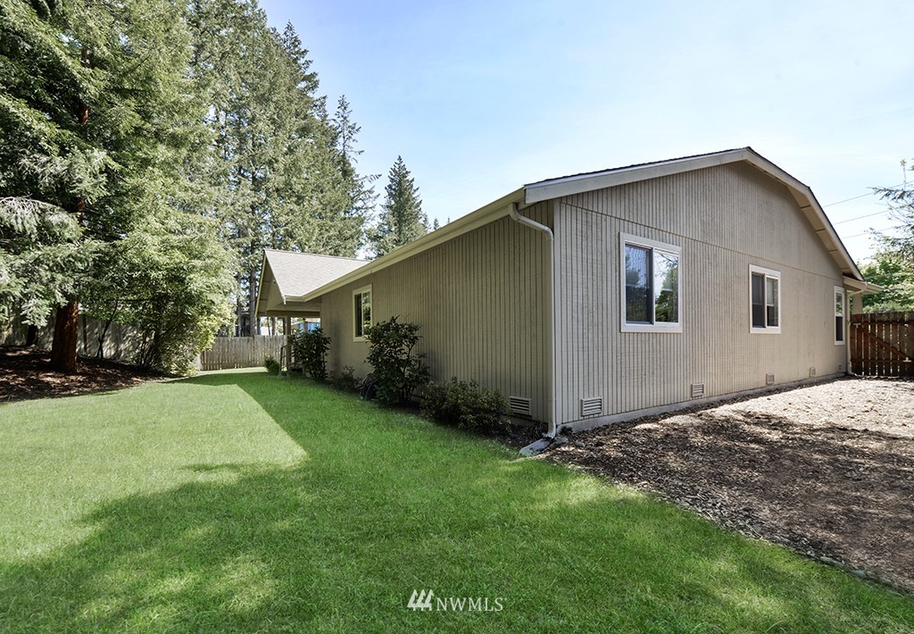 21616 Southeast Wax Road Maple Valley, WA 98038 - Photo 22 of 23 a front view of house with yard and trees in the background