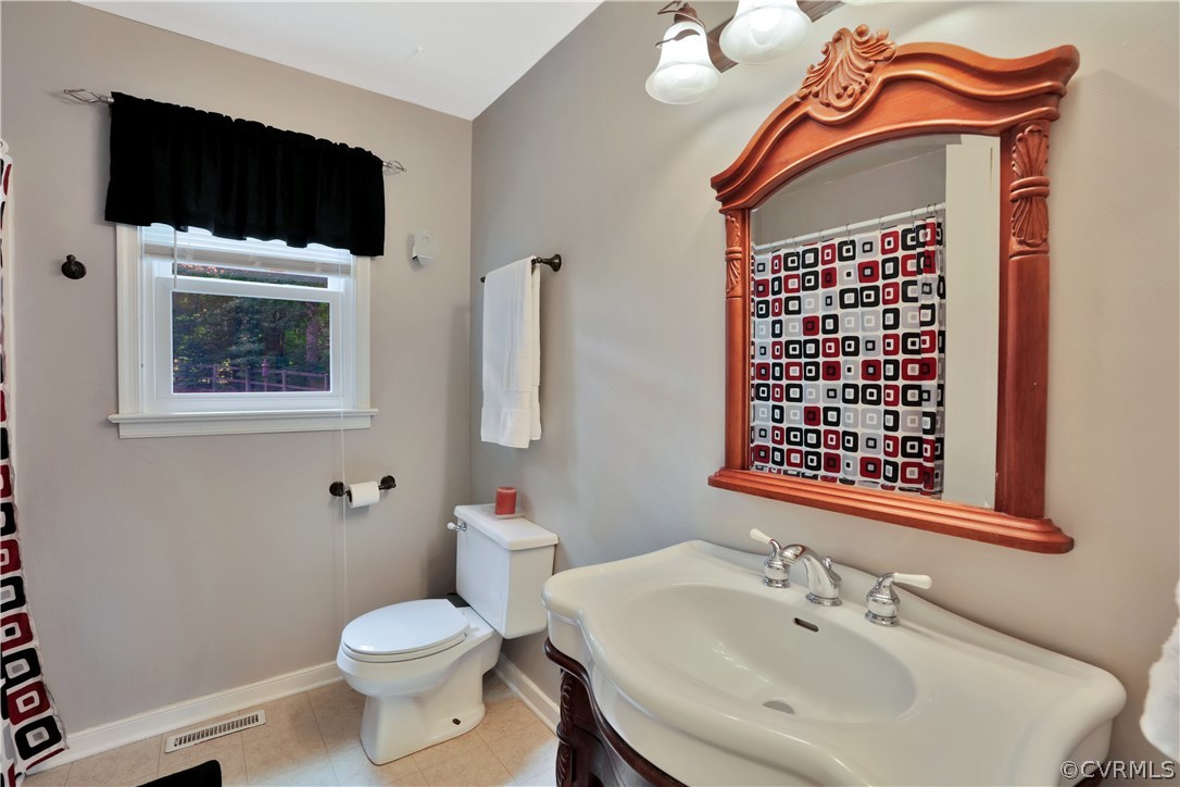 7118 Spring Trace Turn Midlothian, VA 23112 - Photo 17 of 34 a bathroom with a toilet a sink and mirror