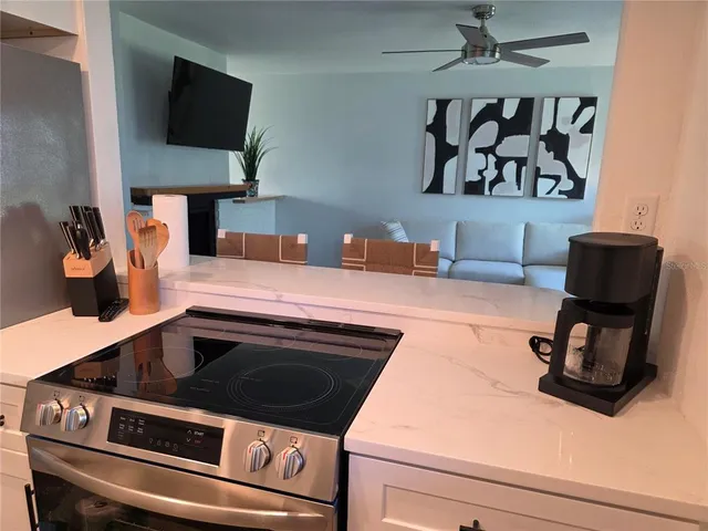 a kitchen with stainless steel appliances granite countertop a sink and a stove