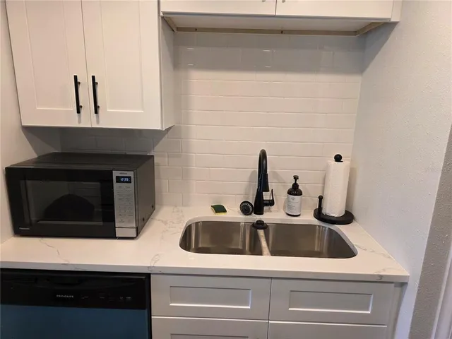a kitchen with a sink and cabinets
