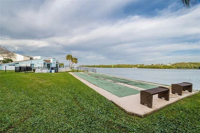 a view of a swimming pool with an outdoor seating and a garden