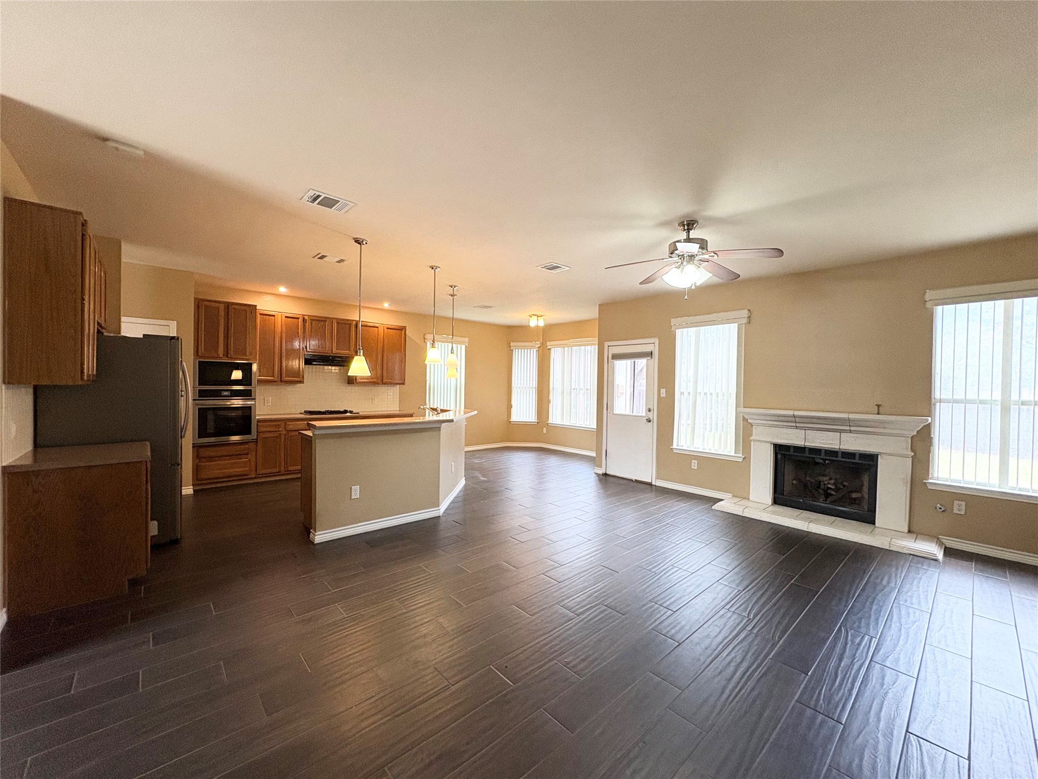 8103 Ephraim Road Austin, TX 78717 - Photo 10 of 35 An open-concept living area combines kitchen, dining, and family spaces for effortless flow and daily enjoyment.