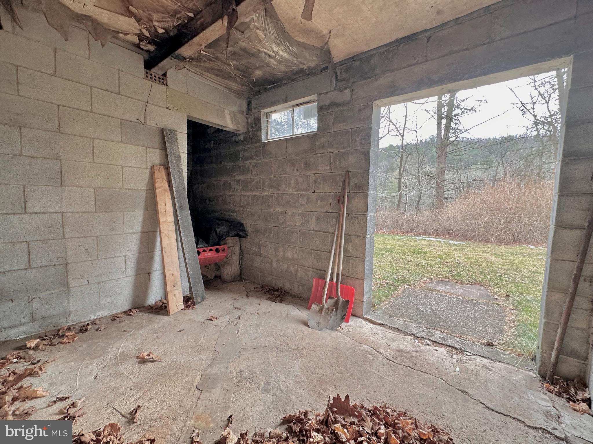 242 Gracey Road Waterfall, PA 16689 - Photo 20 of 40 Walk out level basement with a storage area