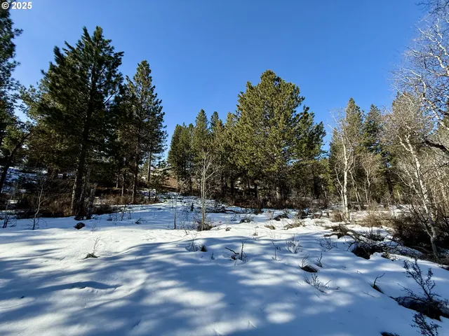 a view of a white house with a yard