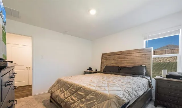 a bedroom with a bed and a window