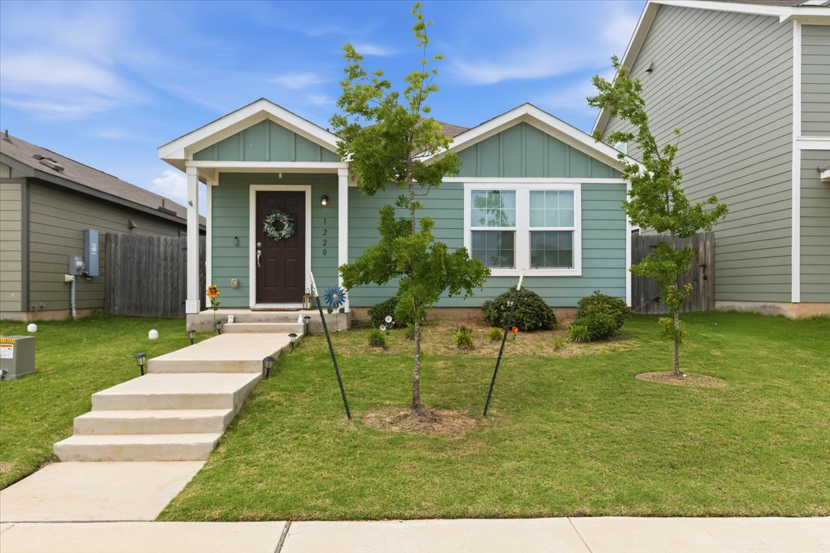 1220 Smallmouth Road Bastrop, TX 78602 - Photo 1 of 29 a view of a house with a yard and plants