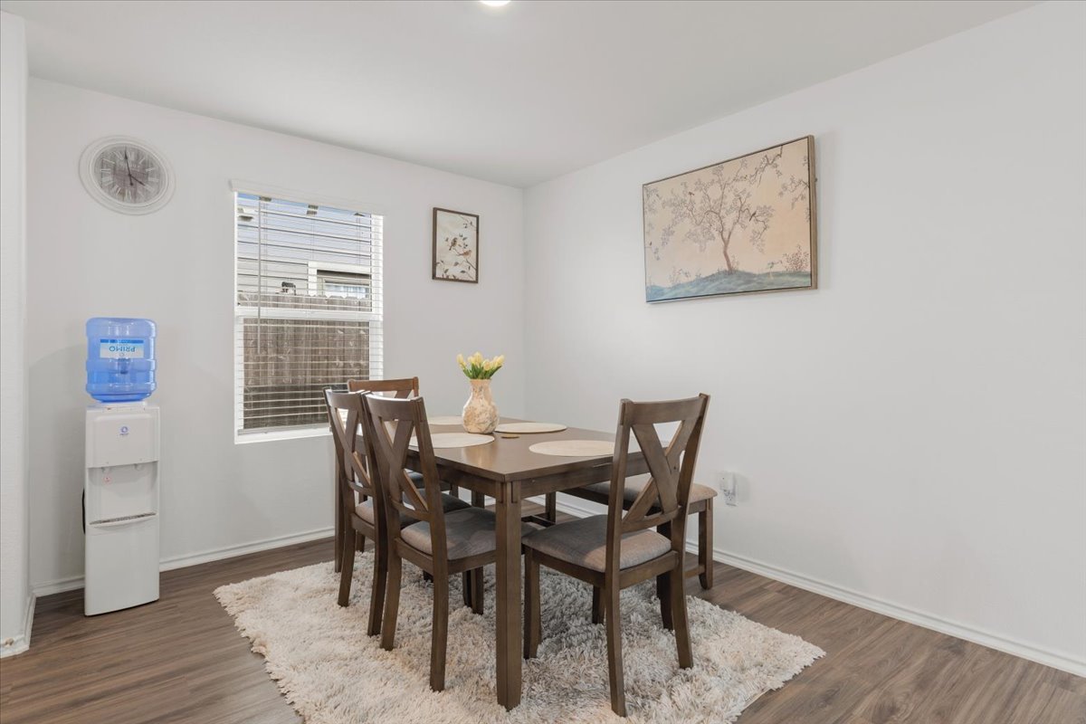 1220 Smallmouth Road Bastrop, TX 78602 - Photo 12 of 29 a view of a dining room with furniture and wooden floor