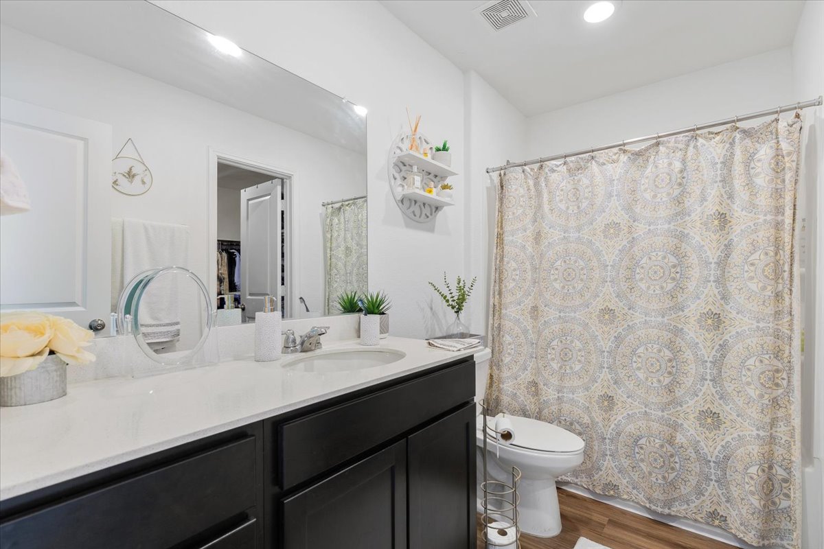 1220 Smallmouth Road Bastrop, TX 78602 - Photo 17 of 29 a bathroom with a double vanity sink toilet and a mirror