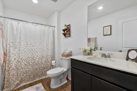 a bathroom with a granite countertop sink toilet and shower
