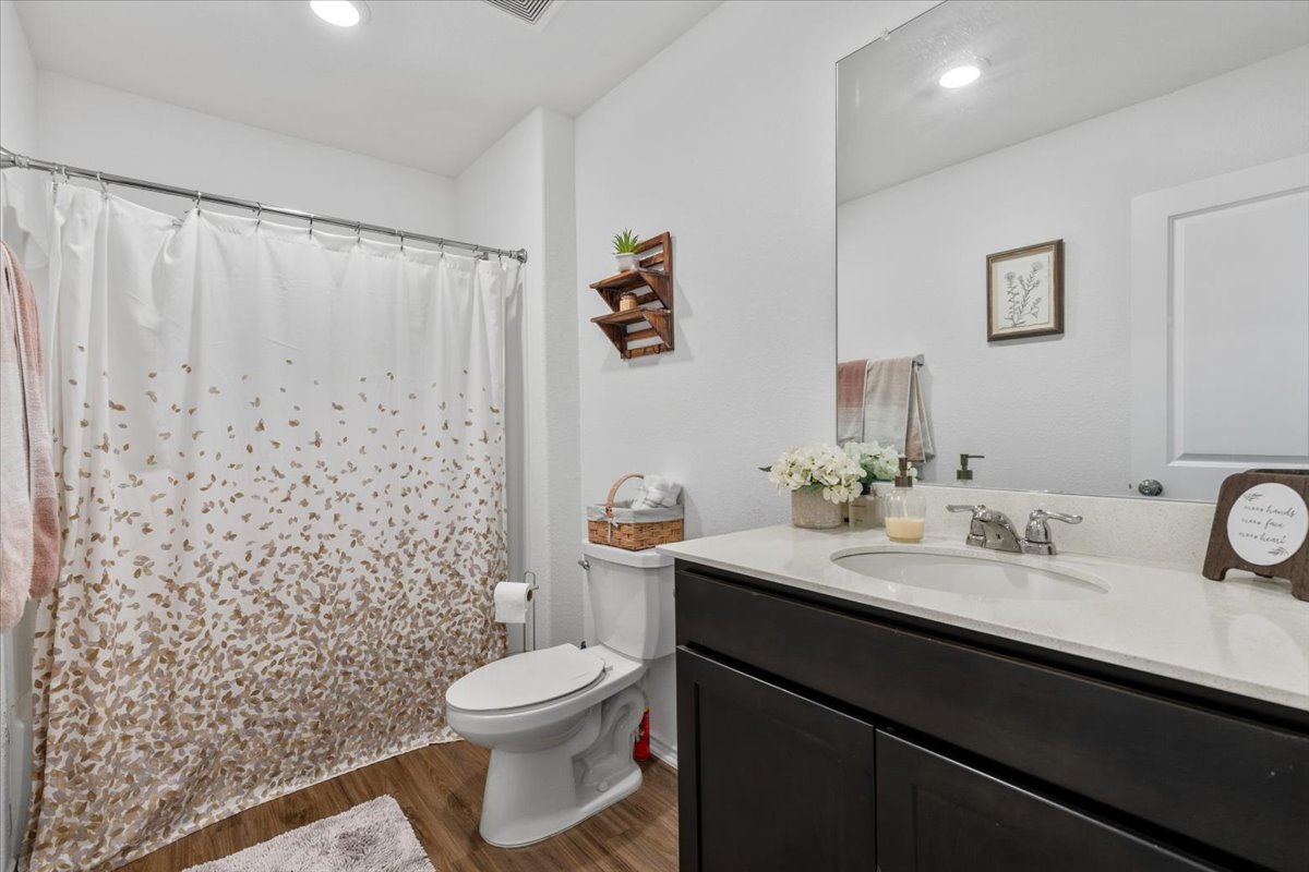 1220 Smallmouth Road Bastrop, TX 78602 - Photo 20 of 29 a bathroom with a granite countertop sink toilet and shower