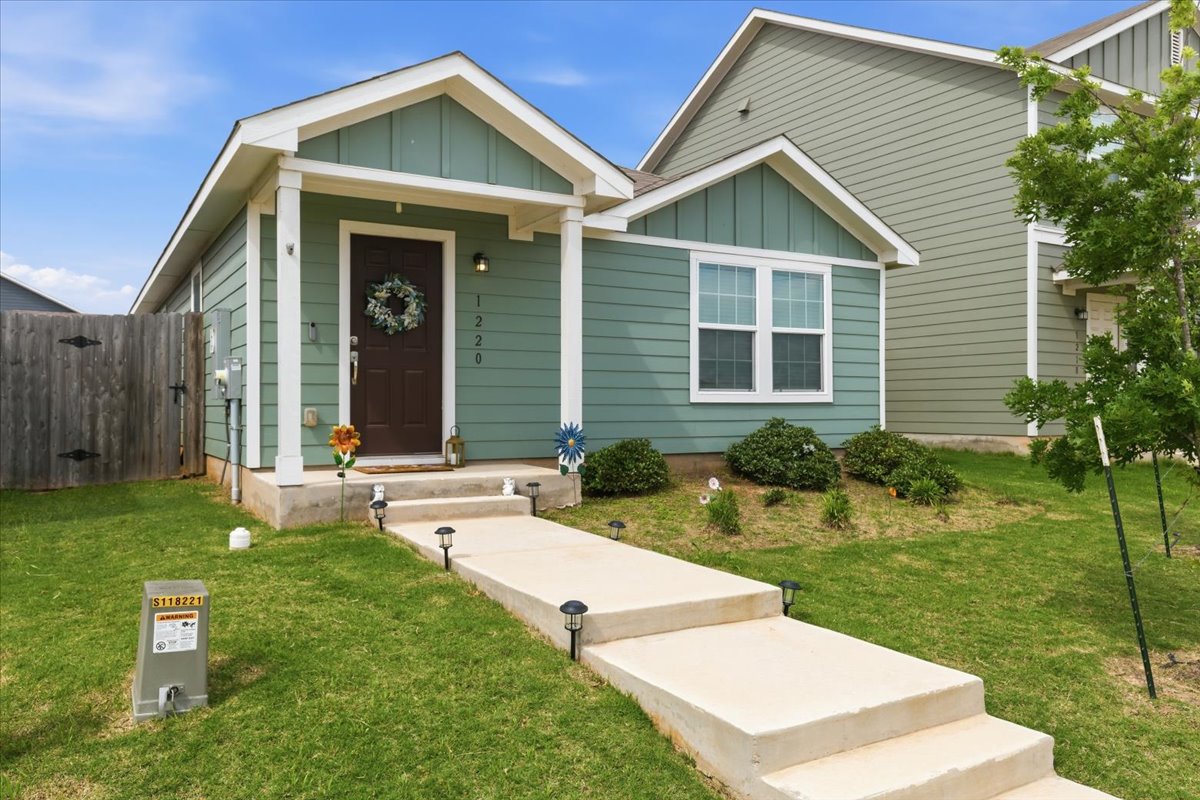 1220 Smallmouth Road Bastrop, TX 78602 - Photo 2 of 29 a front view of a house with a yard