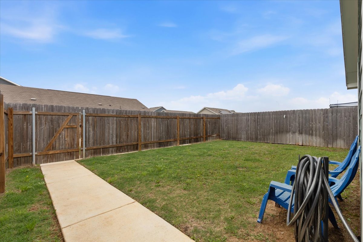 1220 Smallmouth Road Bastrop, TX 78602 - Photo 23 of 29 a view of a backyard with wooden fence