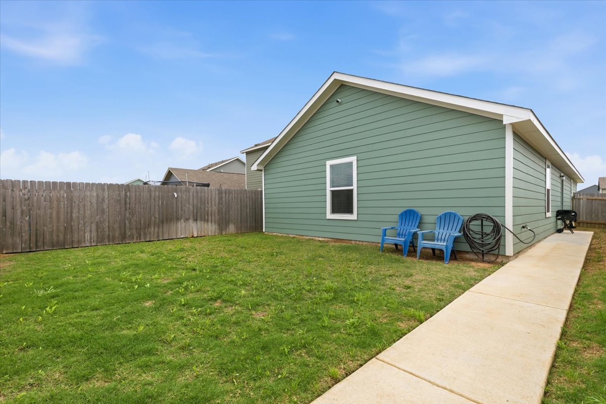 1220 Smallmouth Road Bastrop, TX 78602 - Photo 24 of 29 a view of a backyard with plants and a backyard