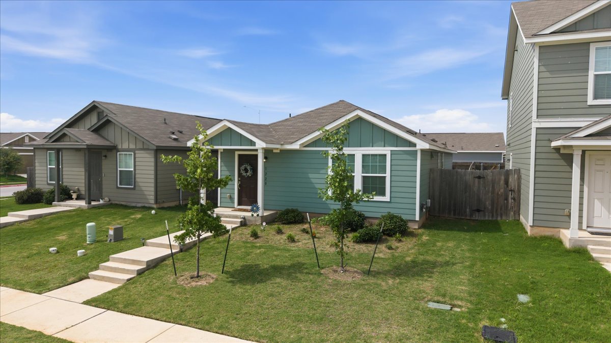 1220 Smallmouth Road Bastrop, TX 78602 - Photo 4 of 29 a front view of a house with garden