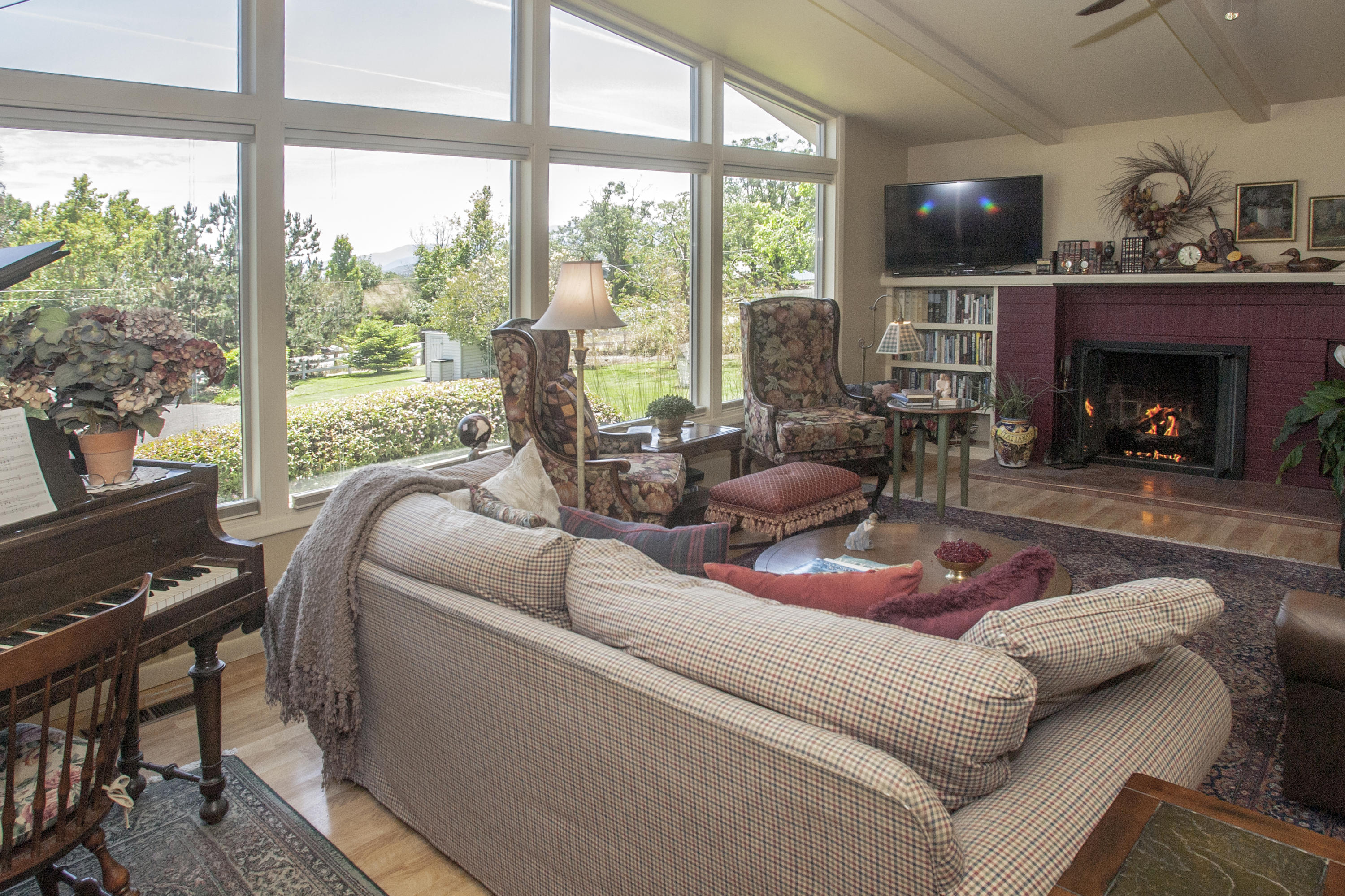1925 Old Stage Road Central Point, OR 97502 - Photo 6 of 34 a living room with furniture a large window and a fireplace