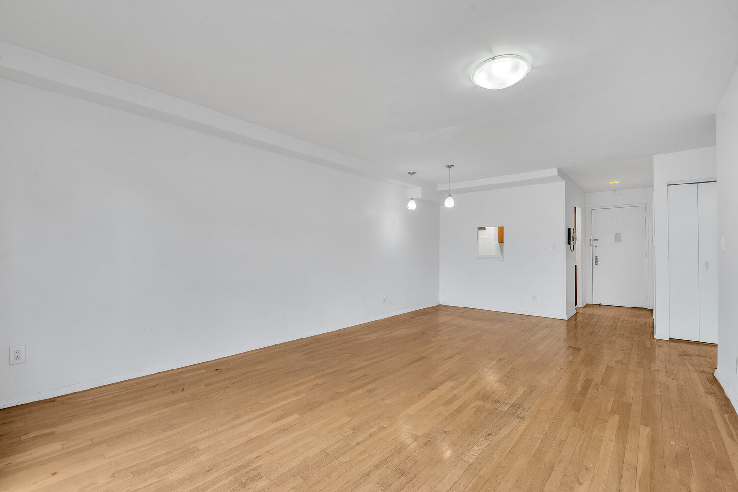 414 West 54th Street, Unit PHE Manhattan, NY 10019 - Photo 4 of 10 a view of empty room with wooden floor