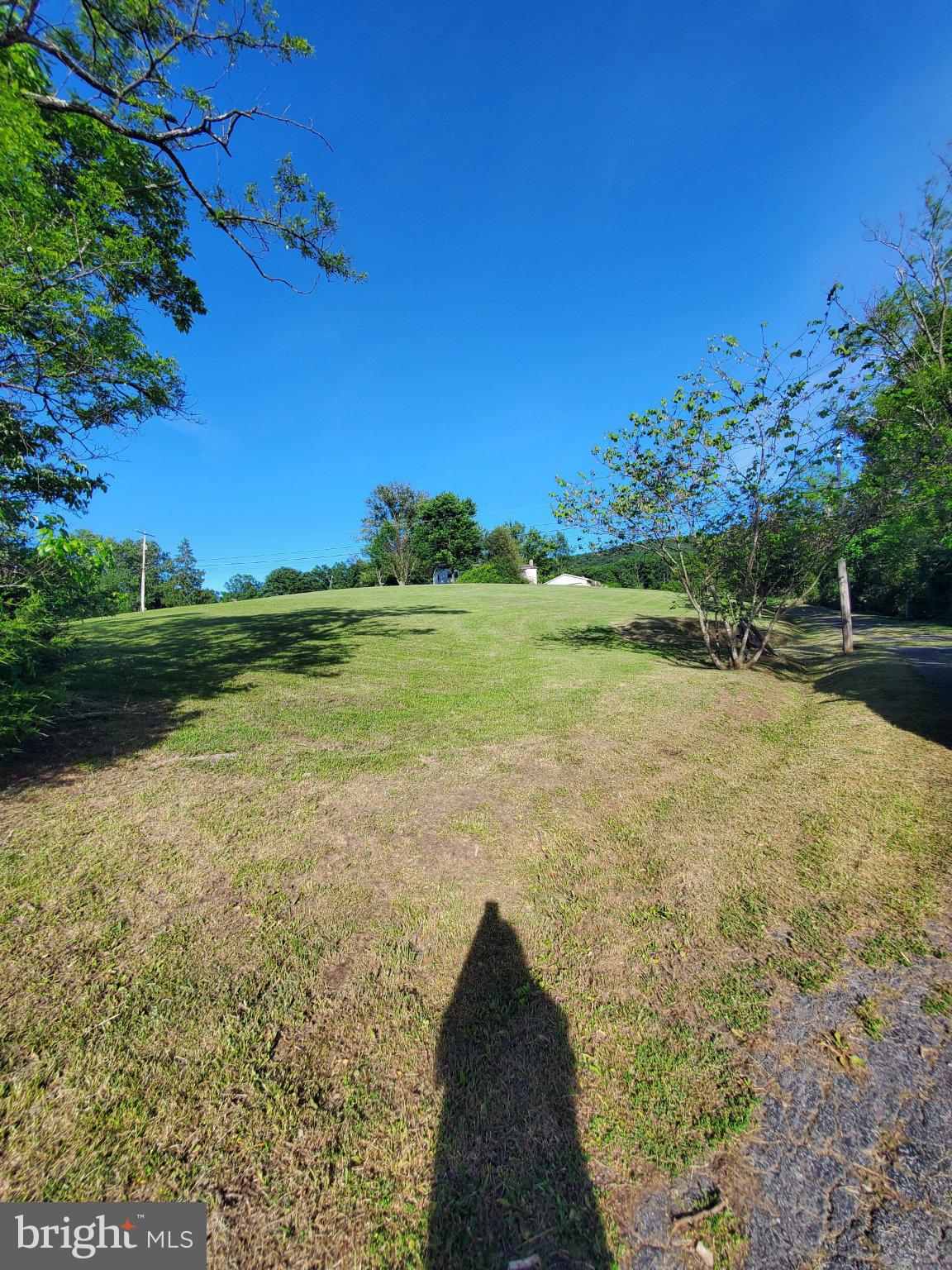 7881 Ford Hill Road Rio, WV 26755 - Photo 24 of 27 Expansive green landscape under blue skies.