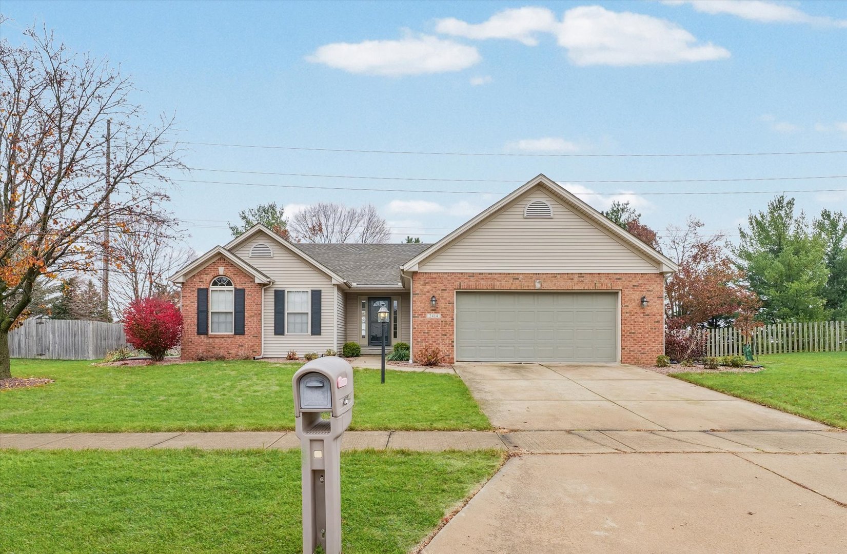 a front view of house with yard and garage