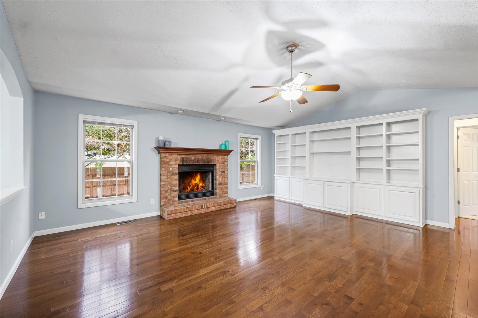 2414 Nugent Circle Urbana, IL 61802 - Photo 5 of 28 an empty room with wooden floor ceiling fan and windows