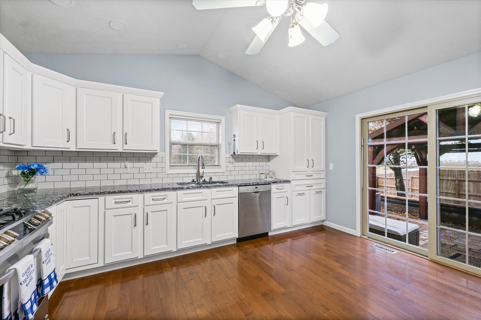 2414 Nugent Circle Urbana, IL 61802 - Photo 9 of 28 a kitchen with granite countertop white cabinets and wooden floor