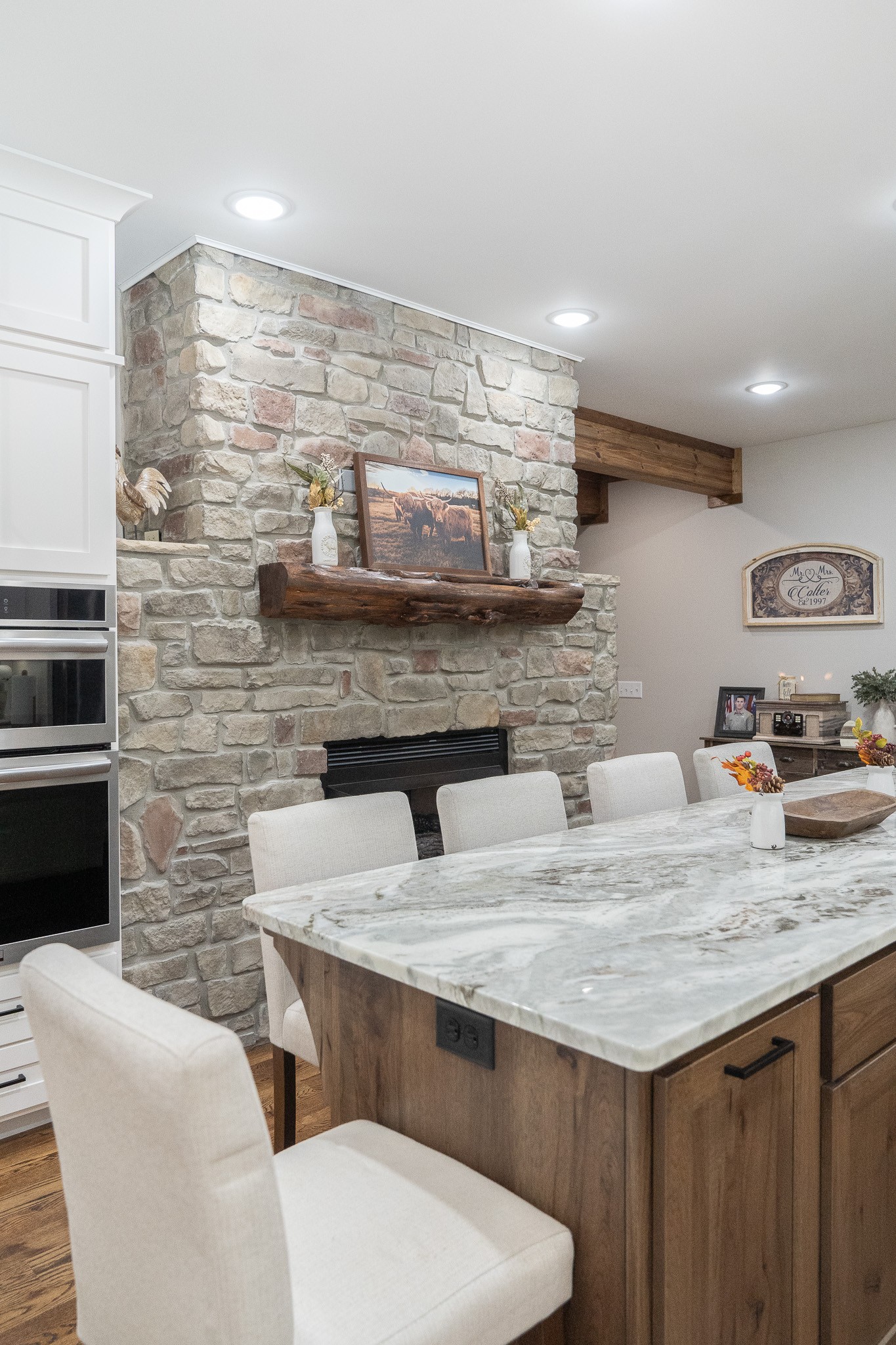 1243 Cave Hill Road Lafayette, TN 37083 - Photo 12 of 32 a kitchen with stainless steel appliances kitchen island granite countertop a table chairs in it