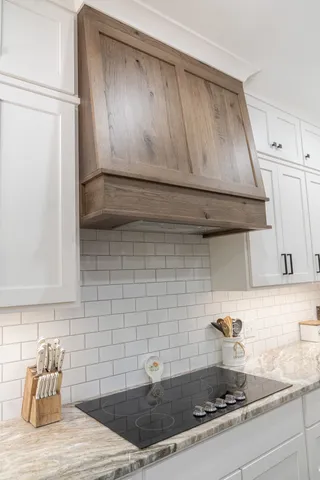 a kitchen with a sink a stove and cabinets