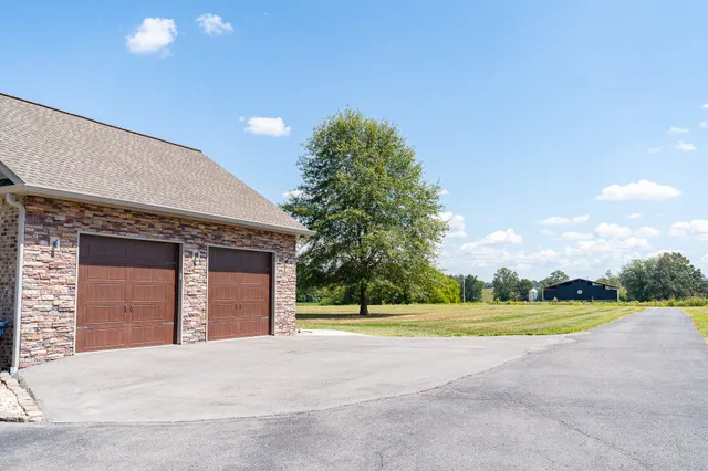 a view of a house with a yard and garage