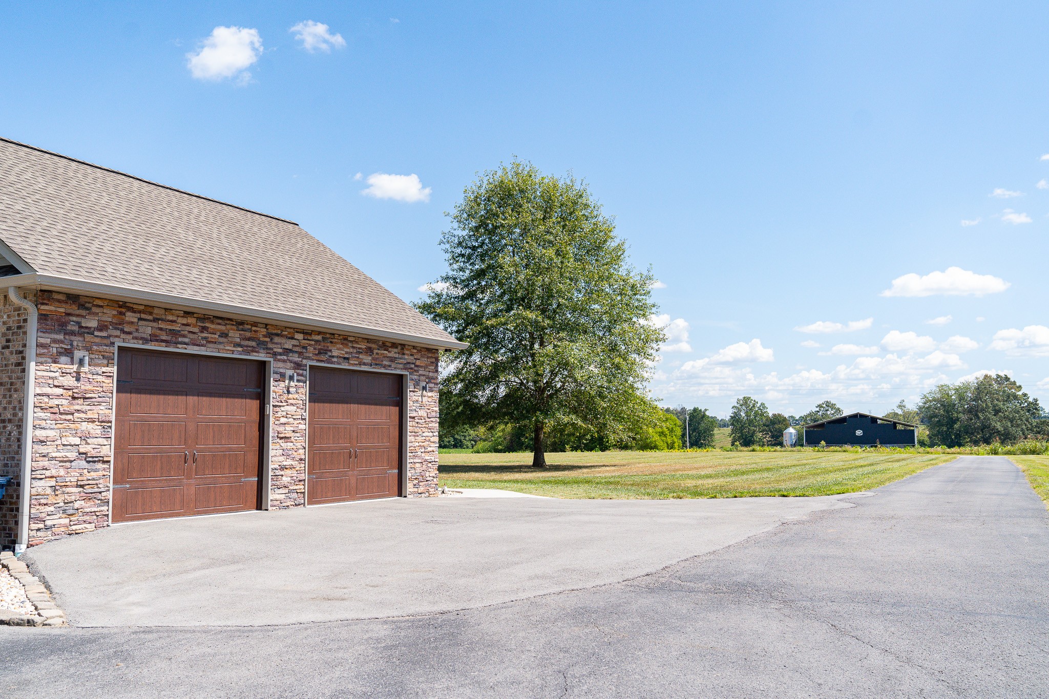 1243 Cave Hill Road Lafayette, TN 37083 - Photo 3 of 32 a view of a house with a yard and garage