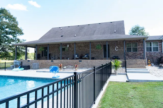 a view of a house with a wooden deck and a yard
