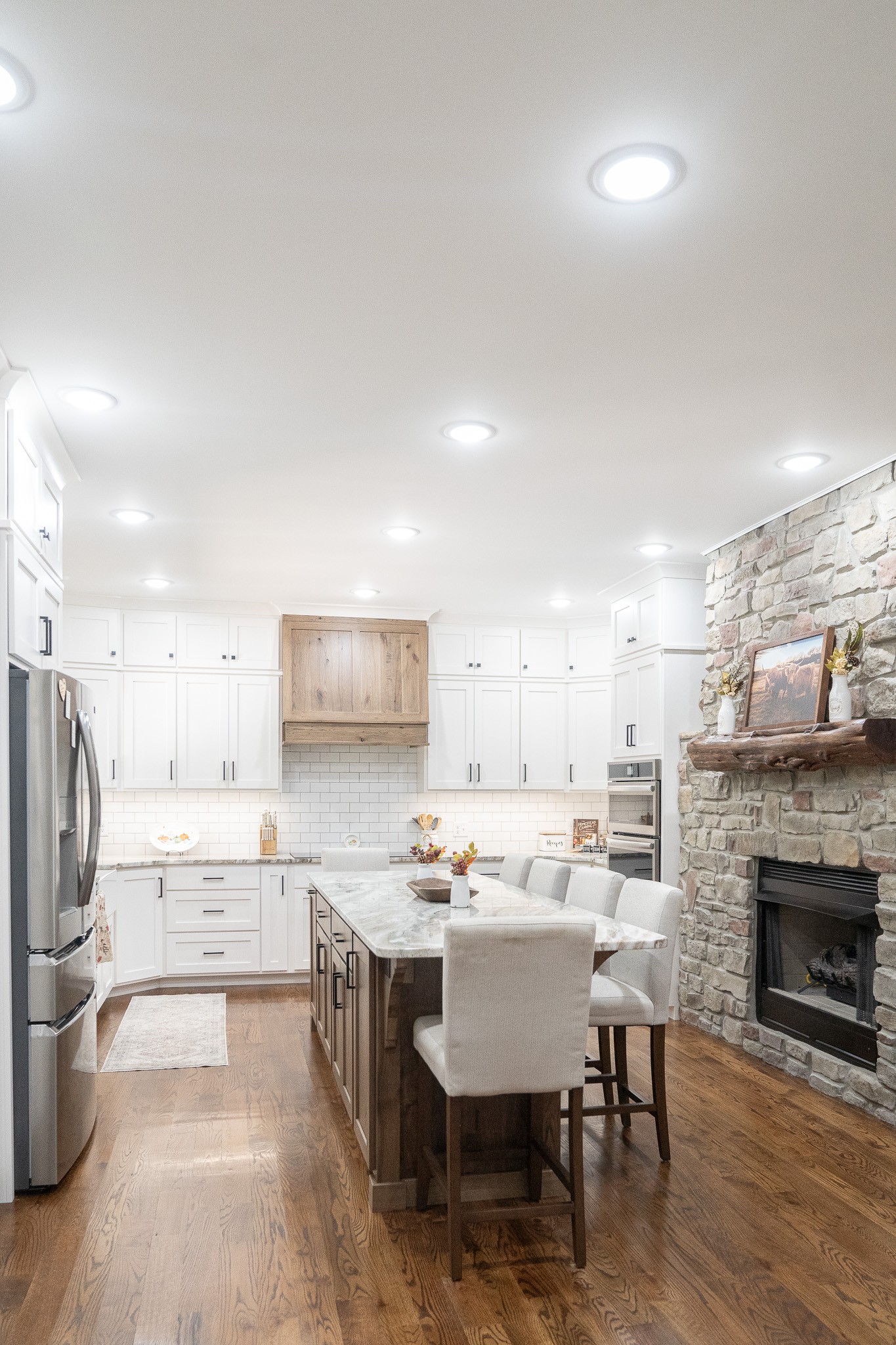 1243 Cave Hill Road Lafayette, TN 37083 - Photo 9 of 32 a kitchen with a dining table chairs refrigerator and cabinets