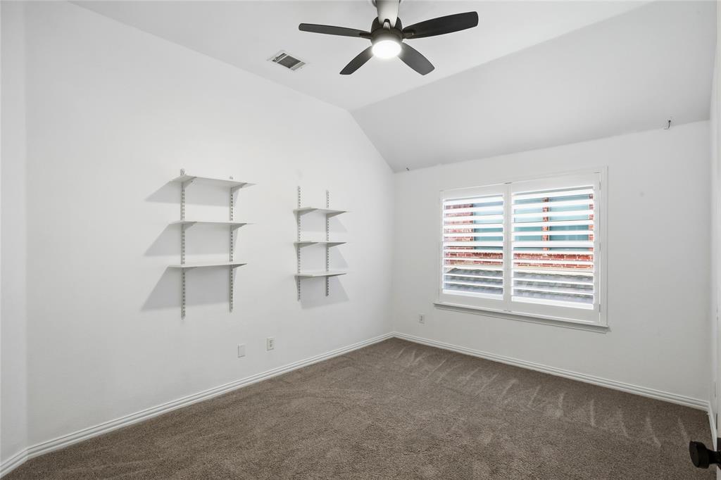 5201 Geode Lane McKinney, TX 75072 - Photo 25 of 37 Another view of spare bedroom with wall shelves. Great size secondary bedrooms..
