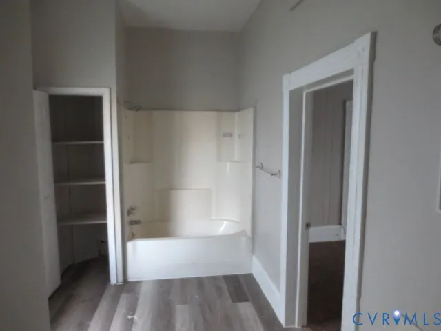 a bathroom with a tub and shower