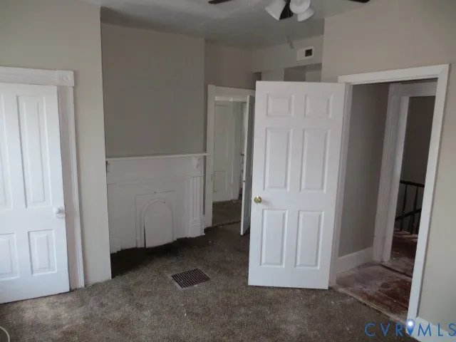 a view of an empty room with a fireplace