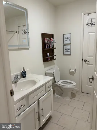 a white toilet sitting next to a bathroom sink