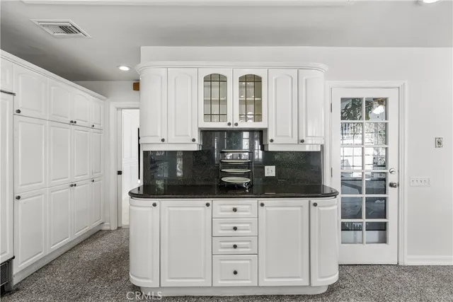 a kitchen with stainless steel appliances a microwave and cabinets