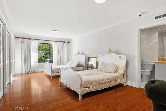a bedroom with a bed and a large mirror
