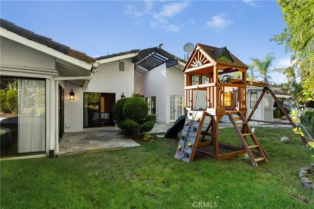 a view of a house with a yard and sitting area